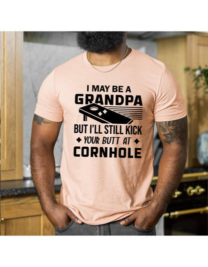 I May Be A Grandpa But I Can Still Kick Your Butt In Cornhole Graphic T-Shirt